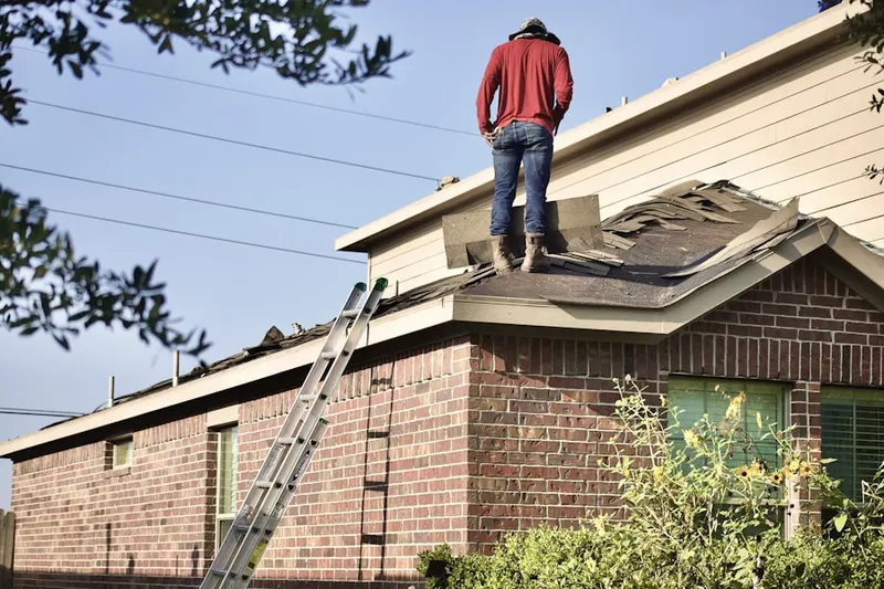 Professional roofer working on a residential roof in Mount Aetna